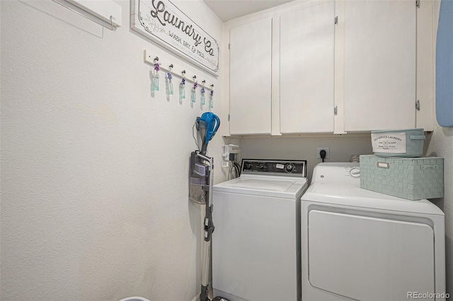 washroom with washer and dryer and cabinet space