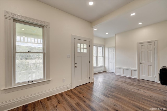 entryway with heating unit, recessed lighting, and wood finished floors