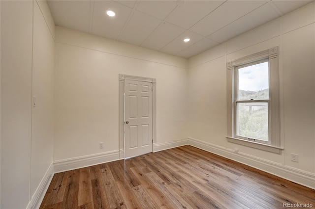 unfurnished room featuring recessed lighting, baseboards, and wood finished floors