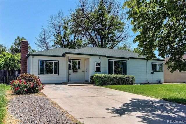 1170 Kingston St, Aurora, CO 80010 - ranch-style house featuring a chimney, a shingled roof, and driveway