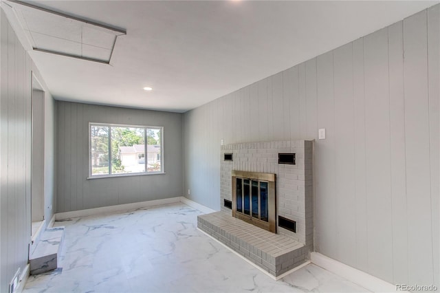 1170 Kingston St, Aurora, CO 80010 - unfurnished living room featuring marble finish flooring, a fireplace, wooden walls, baseboards, and recessed lighting