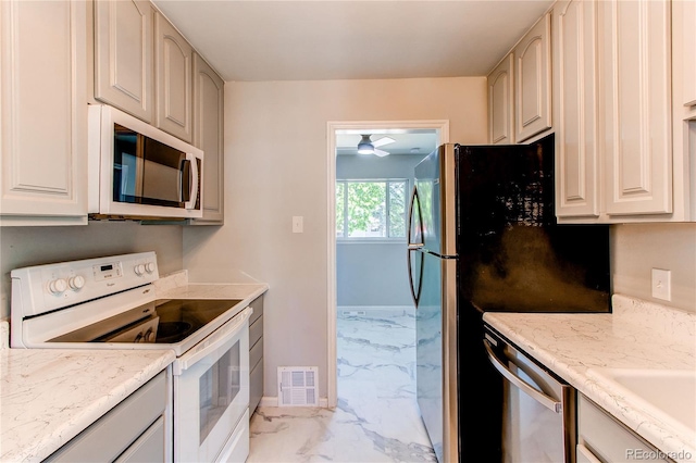 1170 Kingston St, Aurora, CO 80010 - kitchen featuring white appliances, light marble finish flooring, ceiling fan, light stone countertops, and a sink