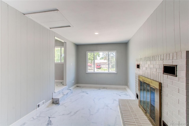 1170 Kingston St, Aurora, CO 80010 - unfurnished living room with marble look tile flooring, a fireplace, baseboards, and wooden walls