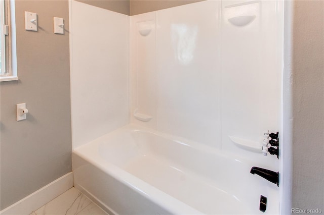 1170 Kingston St, Aurora, CO 80010 - full bathroom with baseboards, marble finish floors, and shower / bath combination