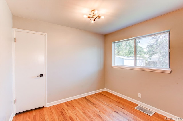 1170 Kingston St, Aurora, CO 80010 - empty room featuring light wood-style floors, baseboards, and a chandelier