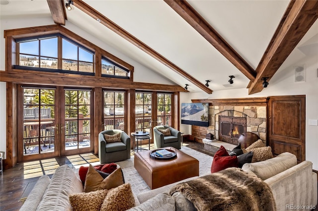 living room featuring wood finished floors, french doors, beam ceiling, a fireplace, and high vaulted ceiling
