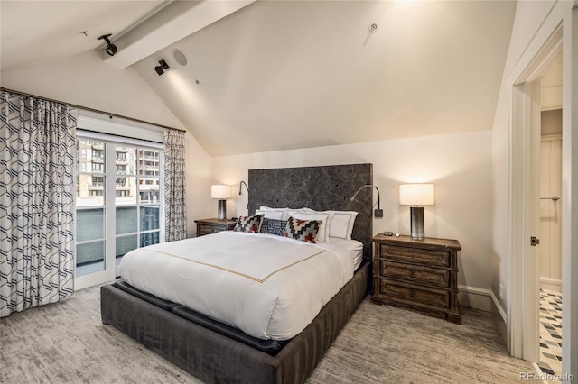 bedroom featuring lofted ceiling with beams and access to outside