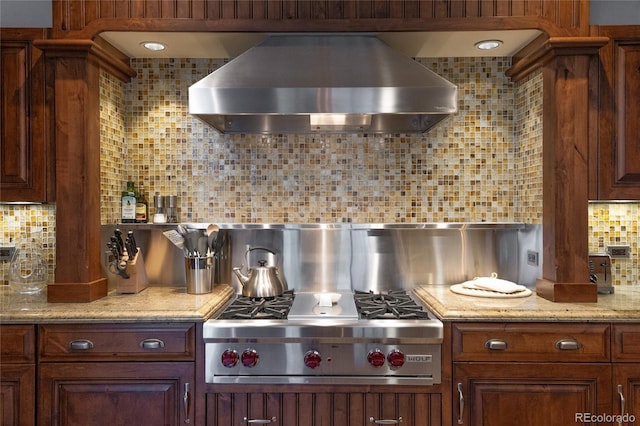 kitchen featuring stainless steel gas cooktop, decorative backsplash, and exhaust hood