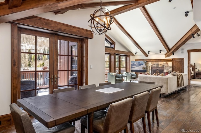 dining room featuring lofted ceiling with beams, french doors, and dark wood-style floors