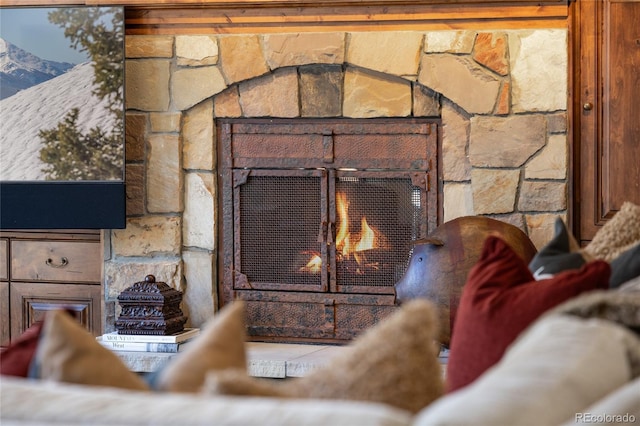 interior details with a stone fireplace and a mountain view