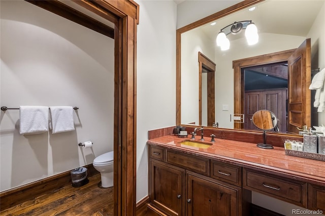 bathroom featuring wood finished floors, vanity, and toilet
