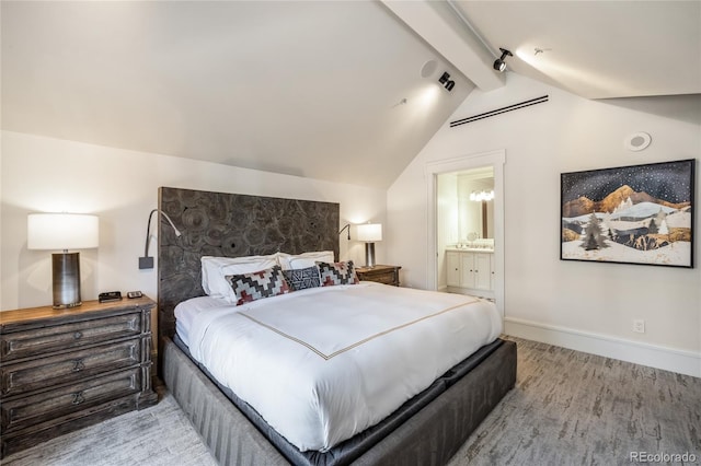 bedroom featuring baseboards, vaulted ceiling with beams, wood finished floors, and connected bathroom