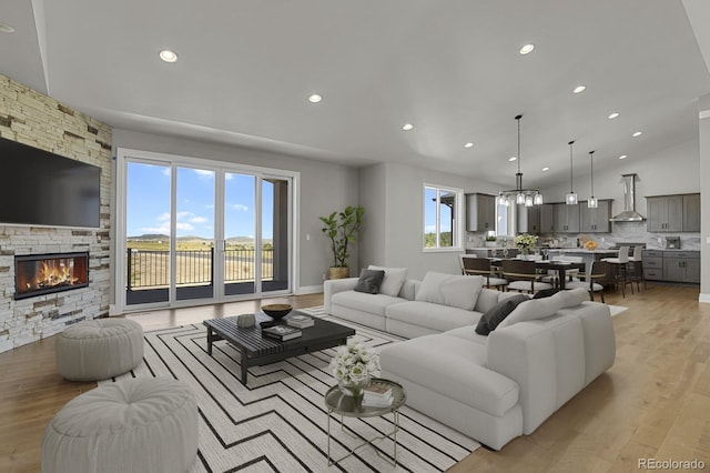 living room with light wood-type flooring and a fireplace