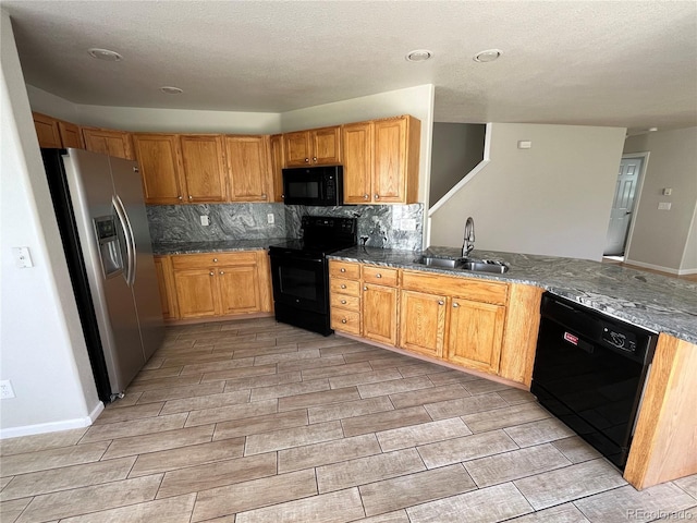 20558 E Grand Ln, Aurora, CO 80015 - kitchen featuring black appliances, a sink, wood tiled floors, decorative backsplash, and dark stone counters