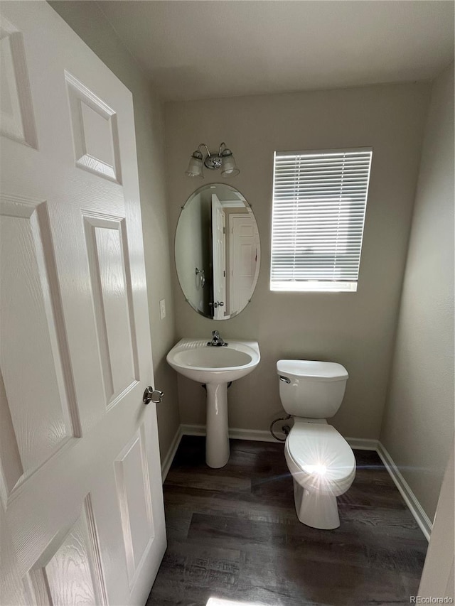 20558 E Grand Ln, Aurora, CO 80015 - half bath with toilet, wood finished floors, and baseboards