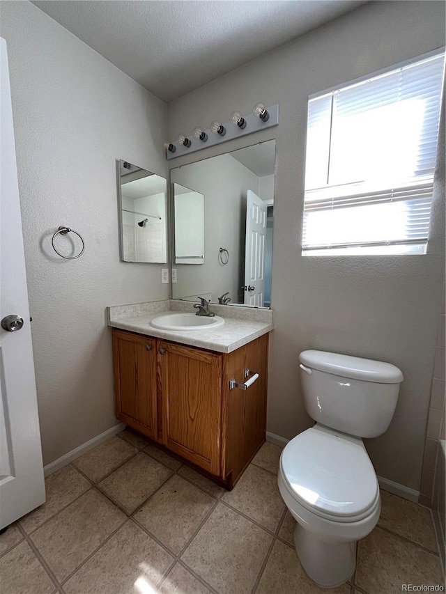 20558 E Grand Ln, Aurora, CO 80015 - full bathroom featuring vanity, toilet, baseboards, and a tub to relax in