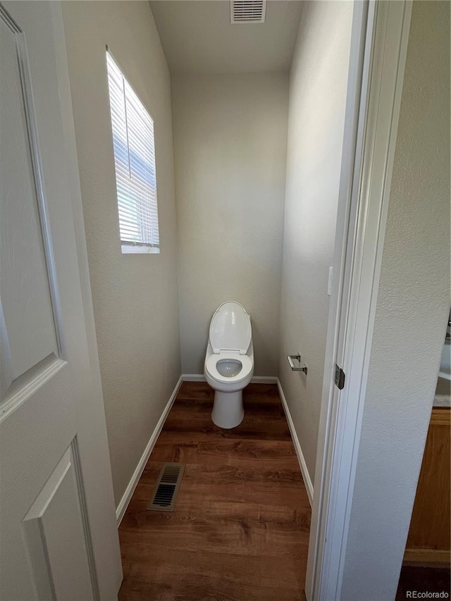 20558 E Grand Ln, Aurora, CO 80015 - bathroom featuring wood finished floors, toilet, and baseboards