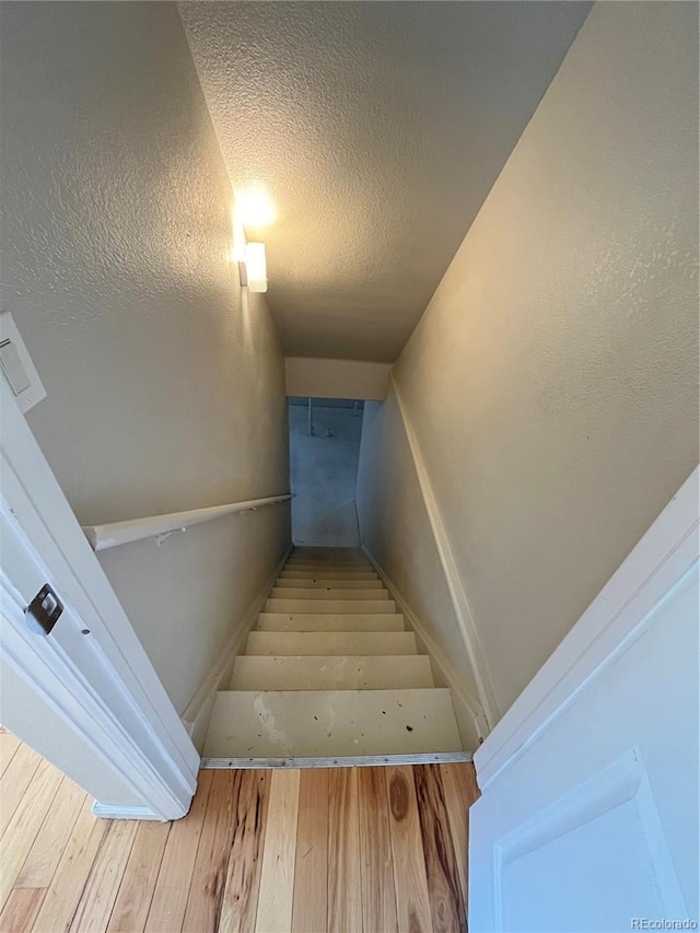 20558 E Grand Ln, Aurora, CO 80015 - stairs featuring wood finished floors and a textured ceiling