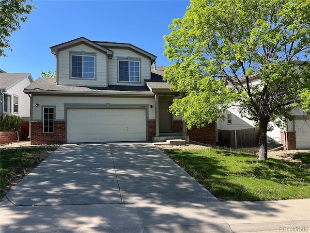 20558 E Grand Ln, Aurora, CO 80015 - view of front of home featuring brick siding, driveway, an attached garage, and a shingled roof