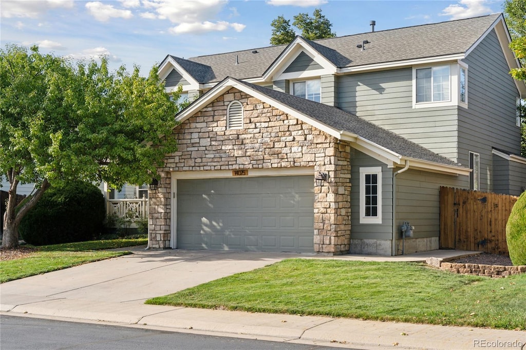 view of front facade with a front yard and a garage