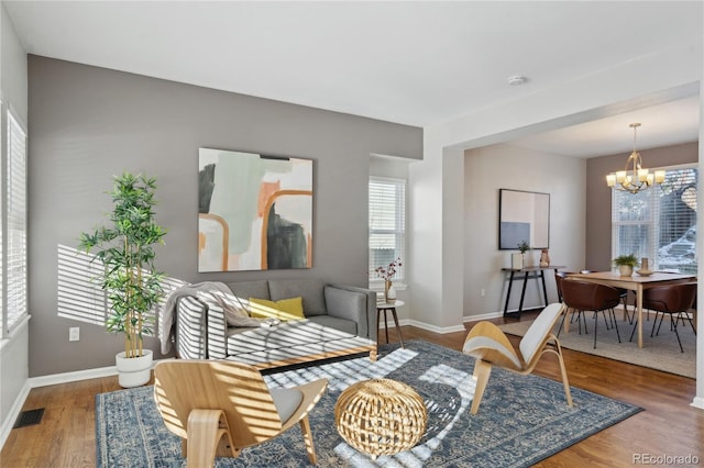 living area featuring hardwood / wood-style floors and a notable chandelier