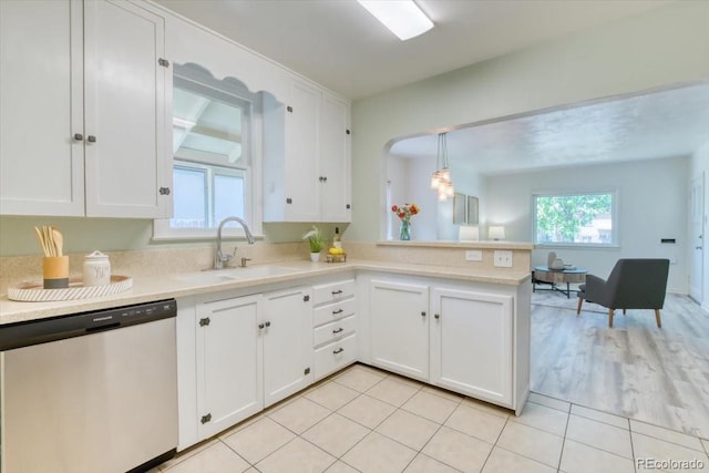 2684 S Logan St, Denver, CO 80210 - kitchen with stainless steel dishwasher, a sink, white cabinetry, and light countertops