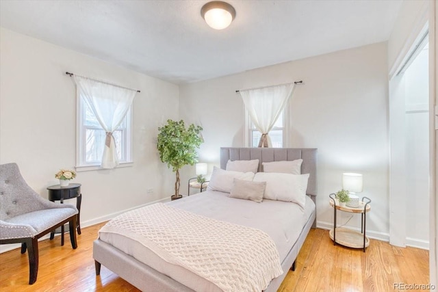 2684 S Logan St, Denver, CO 80210 - bedroom featuring multiple windows, light wood finished floors, and baseboards