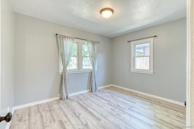 2684 S Logan St, Denver, CO 80210 - empty room featuring wood finished floors, baseboards, and a textured ceiling
