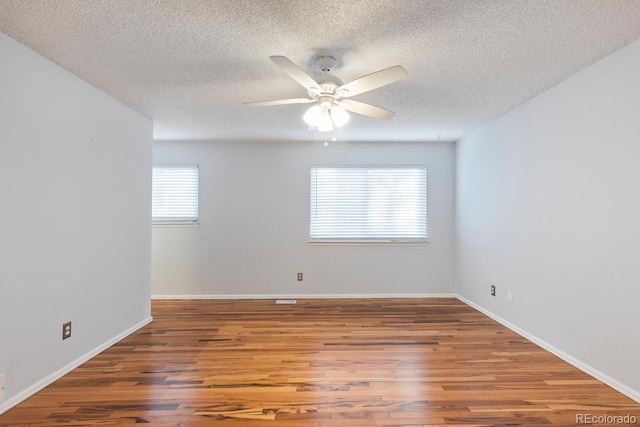 spare room featuring hardwood / wood-style flooring, a textured ceiling, and ceiling fan