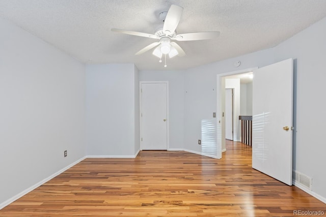 interior space featuring a textured ceiling, ceiling fan, and light hardwood / wood-style flooring