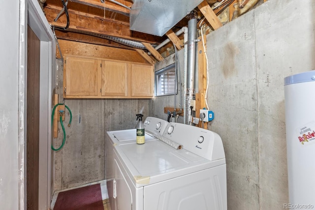 washroom featuring cabinets, water heater, and independent washer and dryer