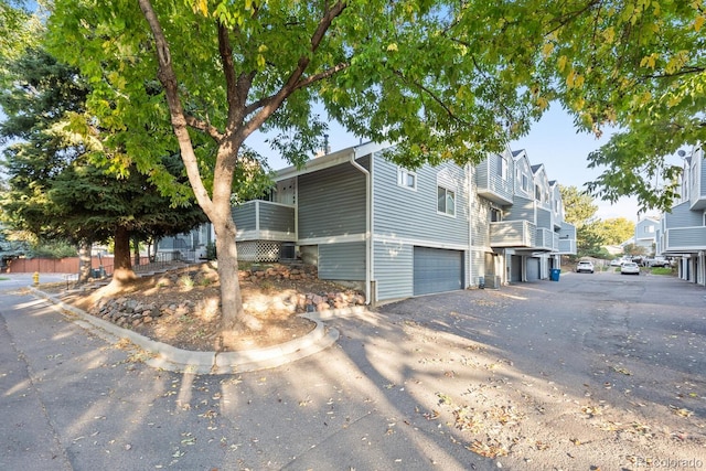 exterior space featuring central air condition unit and a garage