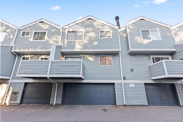 townhome / multi-family property featuring a garage and a balcony