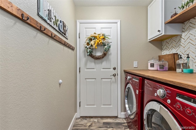 139 N Prairie Falcon Pkwy, Brighton, CO 80601 - laundry area featuring cabinet space, washing machine and clothes dryer, wood finished floors, and baseboards