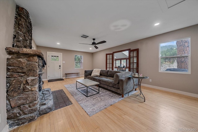 living area with hardwood / wood-style floors, a ceiling fan, baseboards, recessed lighting, and visible vents