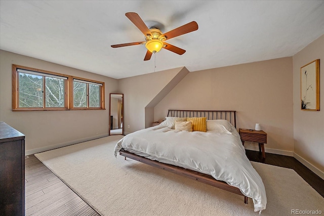 bedroom with baseboards, ceiling fan, and wood finished floors