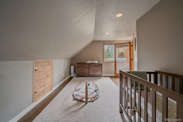 bedroom featuring baseboards, recessed lighting, lofted ceiling, and wood finished floors