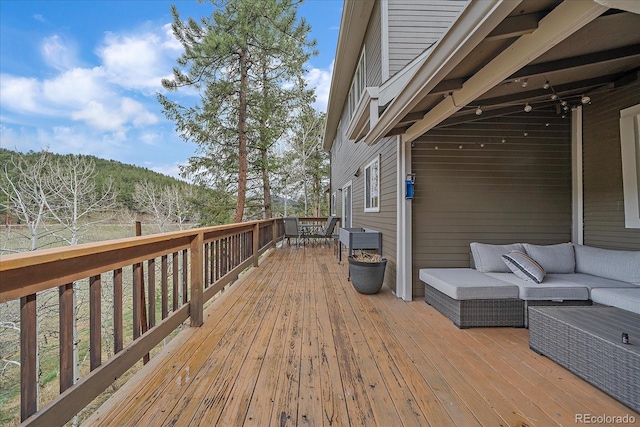 wooden deck featuring outdoor lounge area