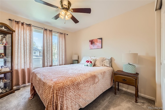 carpeted bedroom featuring baseboards and a ceiling fan