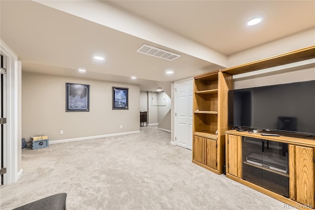 unfurnished living room featuring light colored carpet, visible vents, baseboards, and recessed lighting