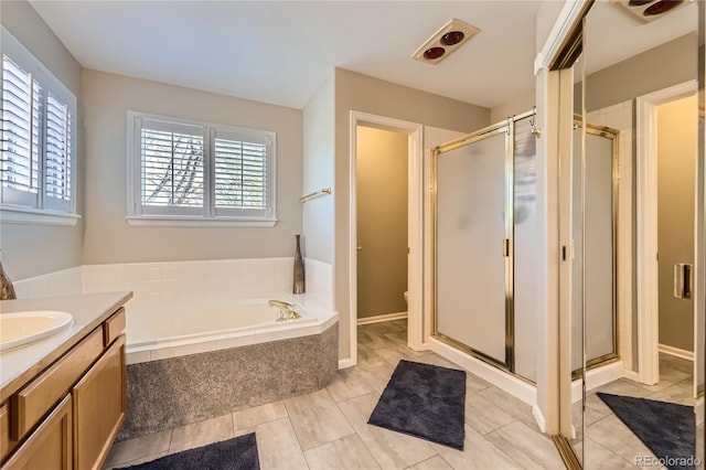 full bath featuring a shower stall, tile patterned floors, vanity, and a bath