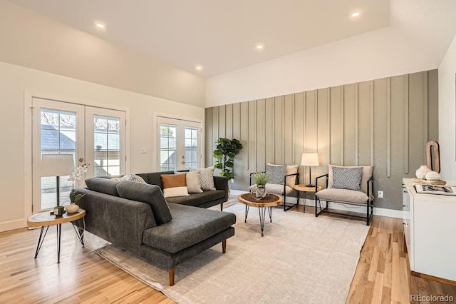 living room featuring french doors and light hardwood / wood-style flooring