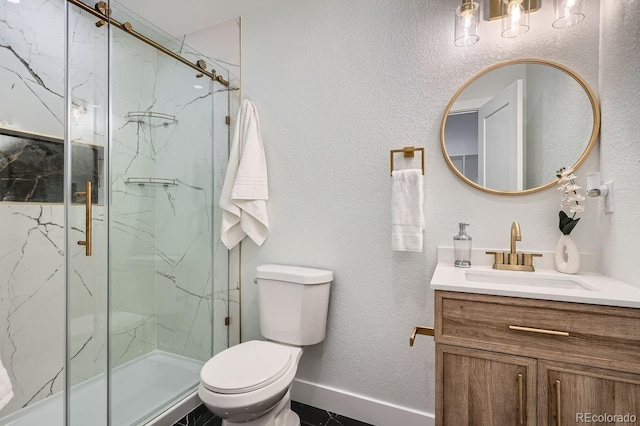 bathroom featuring vanity, toilet, and a shower with door