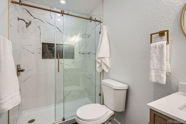 bathroom with vanity, toilet, and an enclosed shower