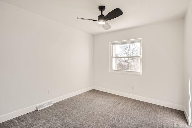 carpeted spare room featuring ceiling fan