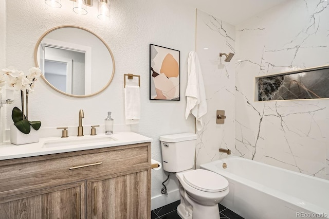 full bathroom featuring vanity, tiled shower / bath, tile patterned floors, and toilet