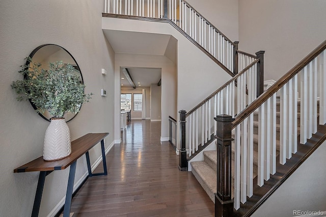 14589 Hagus Pl, Parker, CO 80134 - staircase with wood finished floors, a towering ceiling, and baseboards