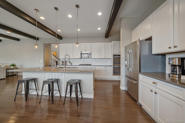 14589 Hagus Pl, Parker, CO 80134 - kitchen featuring stainless steel appliances, a sink, a breakfast bar, beam ceiling, and decorative backsplash