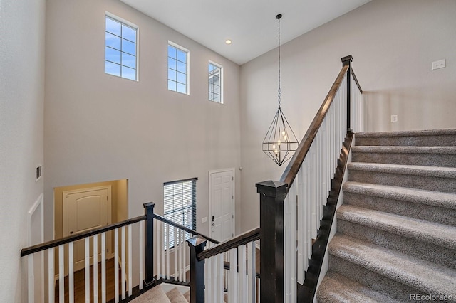 14589 Hagus Pl, Parker, CO 80134 - stairway featuring a high ceiling and a chandelier
