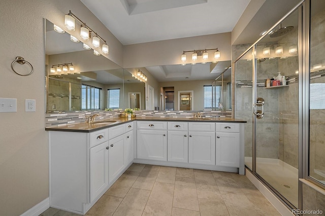14589 Hagus Pl, Parker, CO 80134 - bathroom with a tray ceiling, a stall shower, double vanity, and tile patterned floors